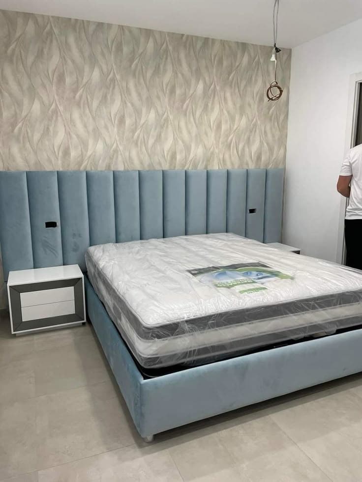 Upholstered bed panel behind a bed