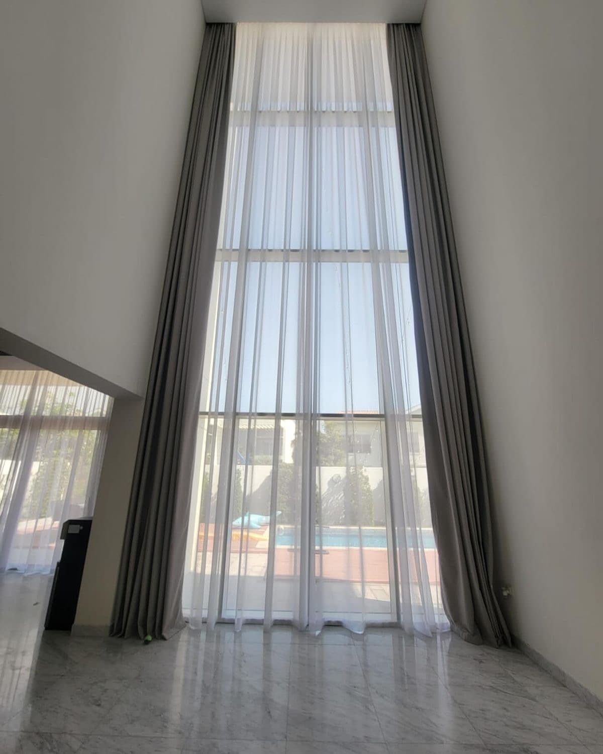 Floor-to-ceiling sheer curtains in a Hyderabad home fitted by Royal Furnishings